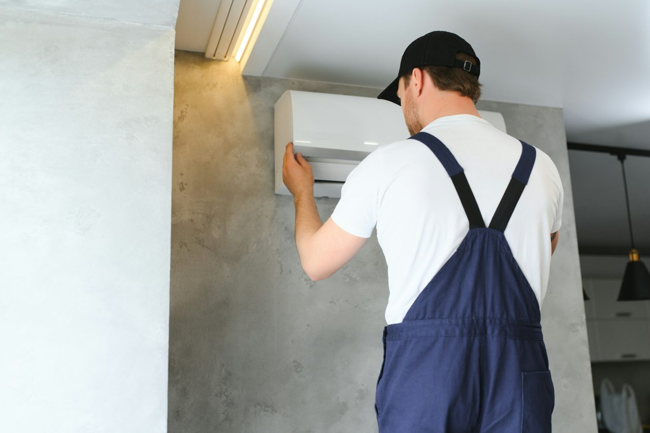 service man is cleaning repair and maintenance of air conditioner 1 4